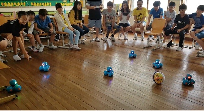 교실에서 학생들이 대시 로봇 축구를 진행하고 있다.