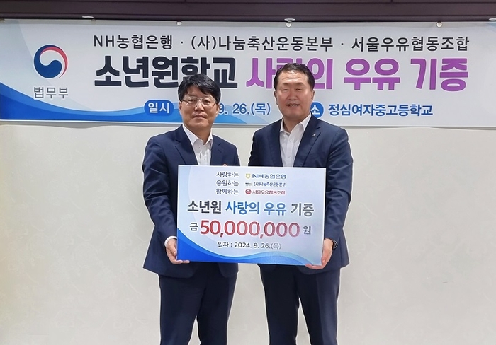 지난 26일 경기도 안양 정심여자중고등학교에서 열린 '사랑의 우유나눔 행사'에서 법무부 이영면 범죄예방정책국장(좌)과 NH농협은행 김문기 부행장(우)이 기념촬영을 하고 있다. 사진=NH농협은행