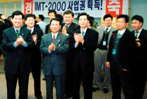 2000년 12월 15일,  IMT-2000 사업권 획득 소식에  당시 조영주 한국통신 IMT-2000사업단장(맨 왼쪽) 등 관계자들이 축하 박수를 치고 있다.