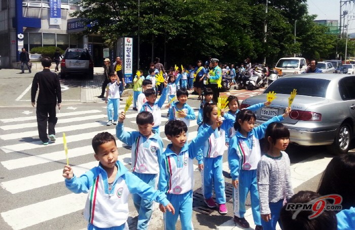 어린이들이 '엄마손'을 이용해 횡단보도를 안전하게 건너는 현장실습을 하고 있다. (사진=쌍용자동차)