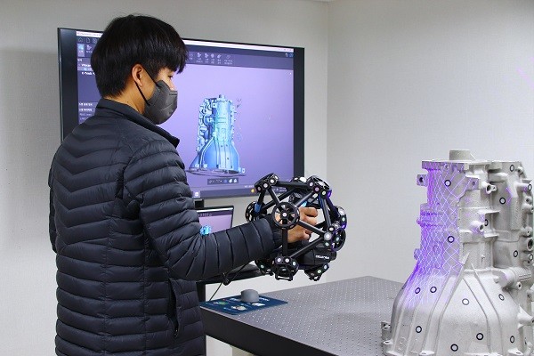 메트롤로지사업부 강주희 팀장이 크레아폼 3D 스캐너 메트라스캔(MetraSCAN 3D)을 시연하고 있다.