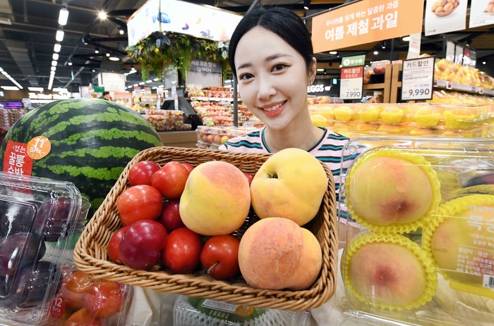 모델이 '여름과일 당도보장 프로젝트' 행사 품목을 선보이고 있다.