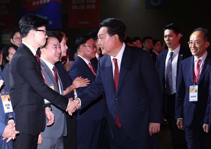 윤석열 대통령이 23일 오후 경기 고양시 킨텍스에서 열린 국민의힘 제4차 전당대회에 입장하며 한동훈 당대표 후보와 인사하고 있다. 연합뉴스