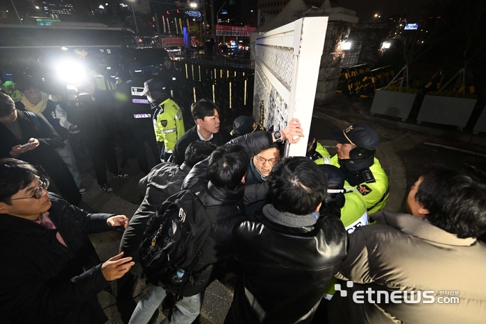 윤석열 대통령이 3일 밤 비상계엄령을 선포한 가운데 폐쇄가 결정된 국회 정문에서 경찰과 국회 관계자들이 대치하고 있다. 사진=전자신문