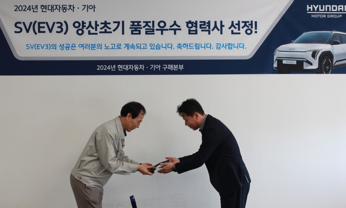 김규남 한국알프스 대표(왼쪽)가 권기성 현대기아차 전자 부품 개발 실장으로부터 품질 우수 협력사 감사패를 받고 있다.