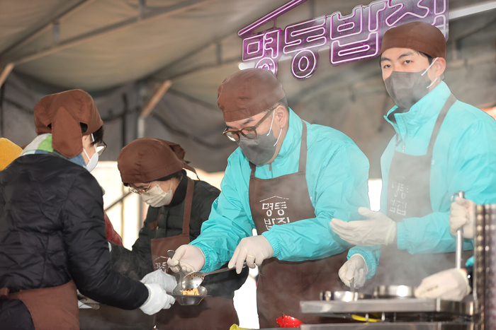 하나금융그룹은 지난 20일 서울 중구 명동대성당 영성센터에서 천주교 서울대교구 산하 한마음한몸운동본부(이사장 유경촌 주교)가 운영하는 무료급식소 '명동밥집'에 1111그릇의 식사를 제공하고 임직원들이 함께 참여하는 봉사활동을 진행했다. 이날 봉사활동에 참석한 이은형 하나금융그룹 부회장(사진 가운데)이 봉사자들과 함께 식사 준비를 돕고 있다. 사진제공=하나금융