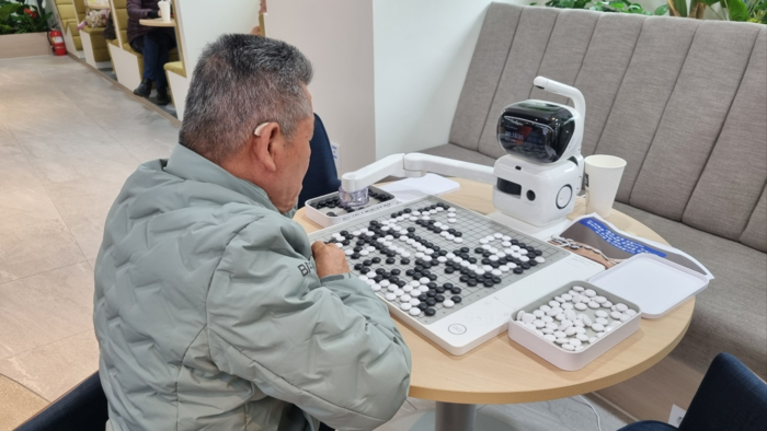 서울디지털동행플라자를 찾은 어르신이 인공지능(AI) 로봇과 바둑을 두고 있다. 서울시 제공