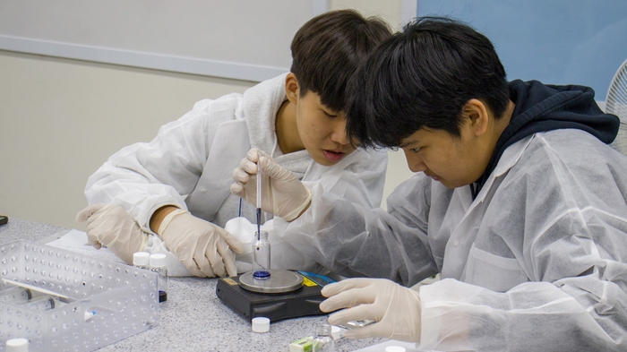 제14회 미래와소프트웨어 꿈찾기 캠프에 참가한 중학생들이 화학 실험을 하고 있다.