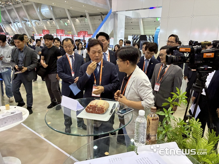 박완수 경남도지사가 개막식 후 VIP 투어 중 경상국립대학교 식육과학연구실 스핀오프 스타트업 '오렌지카우'가 개발한 배양육에 대한 설명을 듣고 있다.