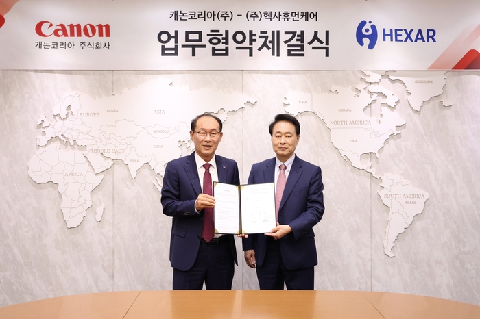 박정우 캐논코리아 대표(왼쪽)와 한창수 헥사휴먼케어 대표가 지난 18일 서울 캐논코리아 본사에서 관절 치료 의료기기 판매를 위한 업무협약(MOU)을 맺었다.