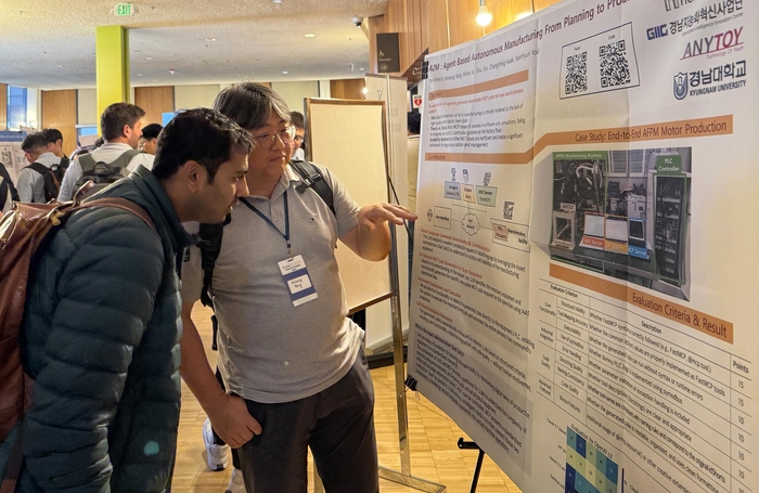 미국 UC버클리에서 열린 경진대회 참가자들이 경남대 경낭지능화혁신사업단 출품 AI 에이전트 기반 자율제조 시스템 개요를 살펴보고 있다.