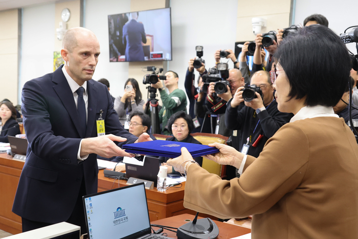 17일 국회 과학기술정보방송통신위원회에서 열린 쿠팡 침해사고 관련 청문회에서 해롤드 로저스 쿠팡 대표이사가 최민희 과방위원장에게 선서문을 제출하고 있다. 연합뉴스