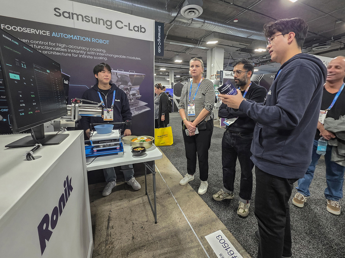 삼성전자 C랩 아웃사이드 기업 '로닉'이 관람객에게 자동화 조리 로봇을 시연하고 있다.