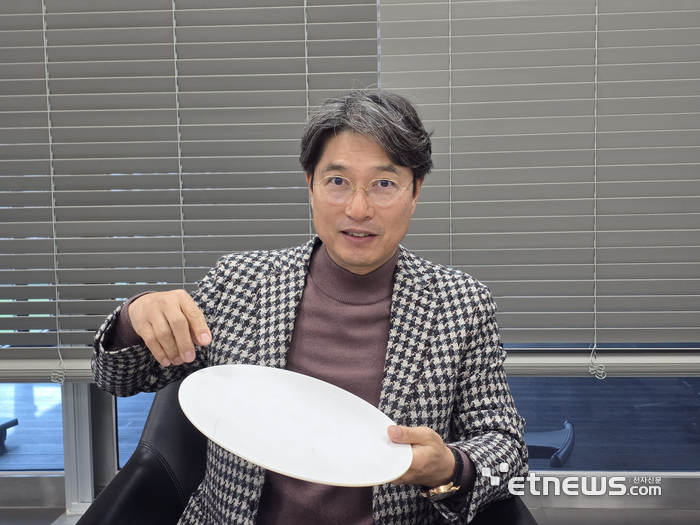 김영곤 이에스티 대표가 반도체 정전척을 들고 설명하고 있다. (사진 = 김영호 기자)