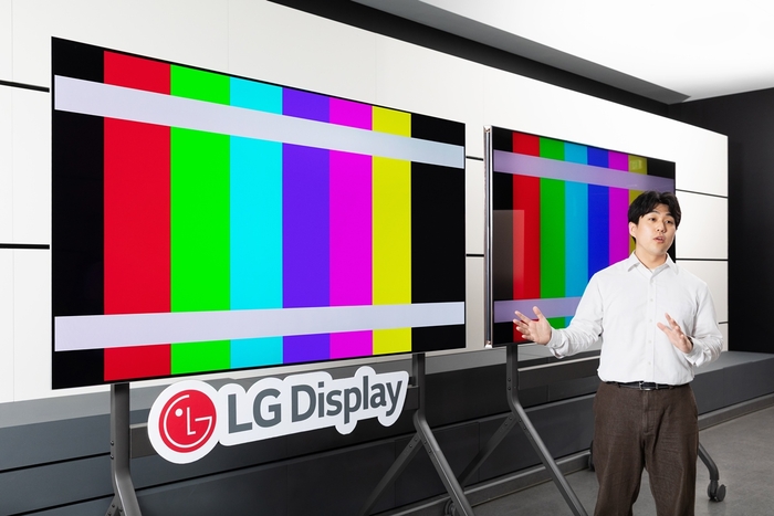 LG디스플레이 임직원이 '색·밝기 정확도' 인증을 획득한 탠덤 화이트(W) OLED 제품을 설명하고 있다. 〈사진 LG디스플레이 제공〉