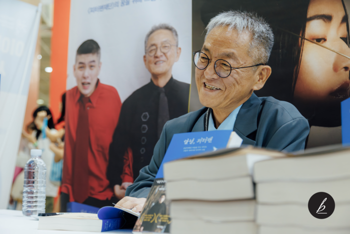 지난 26일 서울 강남구 코엑스에서 열린 서울국제도서전에서 전경철 작가가 독자 책에 사인하고 있다. 〈자료 카카오〉