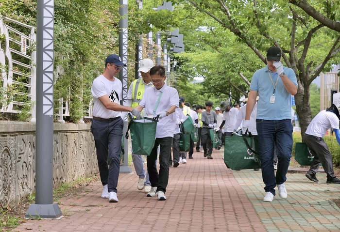 니콜라 파리 사장(왼쪽)이 르노코리아 임직원과 환경 정화 활동을 하고 있다.