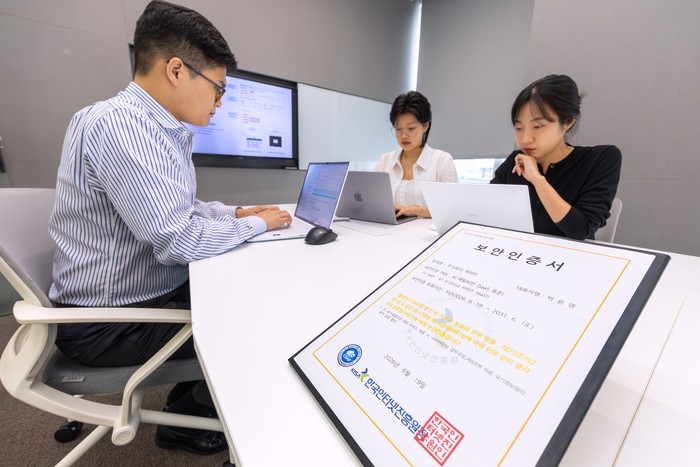 KT 직원이 CSAP 보안인증서와 함께 근무하는 모습
