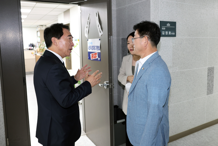박수현 충남 지사가 김정호 위원장실 문 앞에서 발전사 통합 본사 충남 유치 당위성 등 충남 현안을 설명하고 있다.
