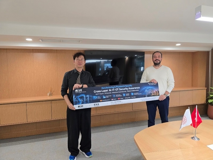 강장묵 교수(왼쪽)가 빌리심 바디시 회의실에서 현지 관계자와 AI·산업 보안 협력 의제가 적힌 현수막을 들고 기념촬영하고 있다.