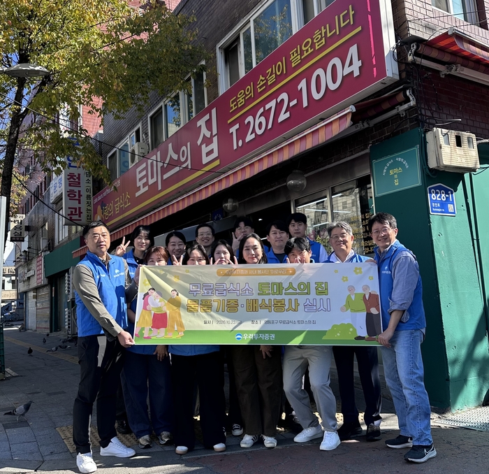 우리투자증권 사내봉사단 '이로우리' 직원들이 지난 23일 서울 영등포구 소재 무료급식소 '토마스의 집'에서 봉사활동을 마친 뒤 기념사진을 촬영하고 있다.