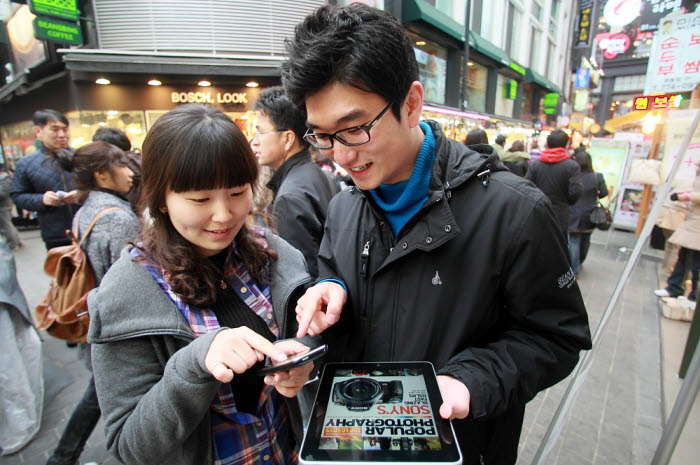 KT 고객들이 서울 명동거리에 `CCTV 와이파이` 구역에서 무선인터넷 서비스를 이용하고 있다.