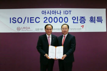 김창규 아시아나IDT 사장(왼쪽)이 유상근 로이드인증원코리아 사장으로부터 ISO/IEC20000을 수여받은 후 기념촬영을 하고 있다