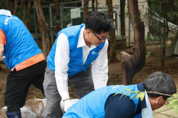 유만식 한국환경공단 경영지원본부장(가운데)이 한국환경공단 에코봉사단과 함께 토사를 치우며 수해복구 작업을 벌이고 있다.