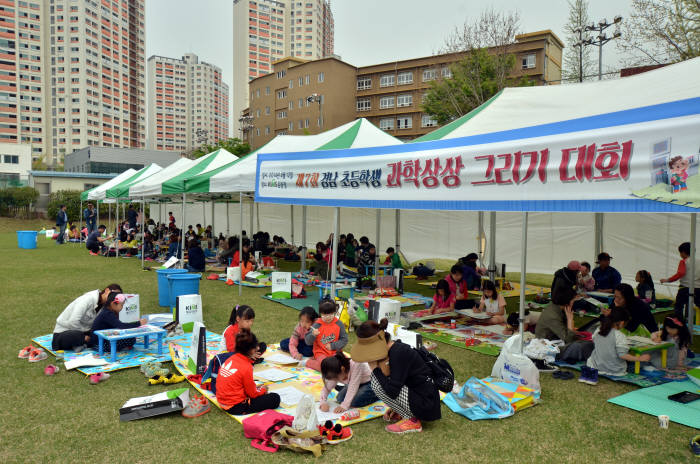 12일 재료연구소 운동장에서 열린 `초등학생 과학상상 그리기 대회`에서 참가 학생들이 과학기술로 달라진 미래 생활을 주제로 그림을 그리고 있다.