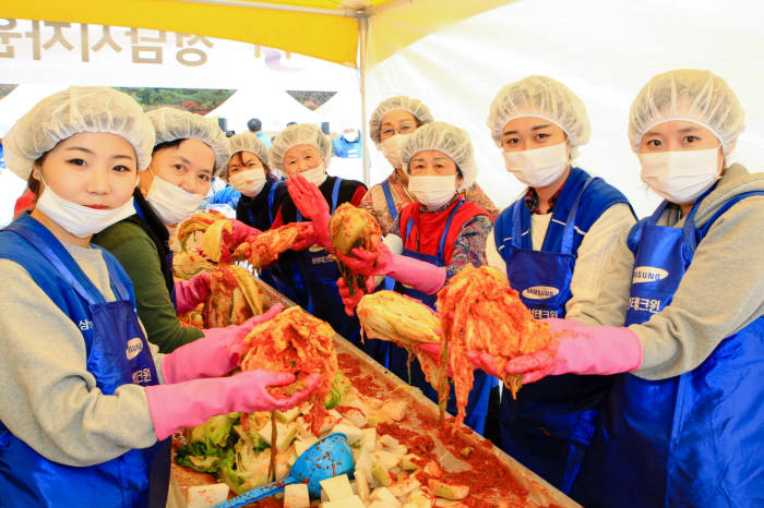 지난 11일 경기 성남시 황새울광장에서 삼성테크윈 임직원과 지역주민들이 함께 배추농가 지원과 소외계층에 도움을 주기 위해 김장을 담그고 있다. <사진=삼성 사회봉사단>