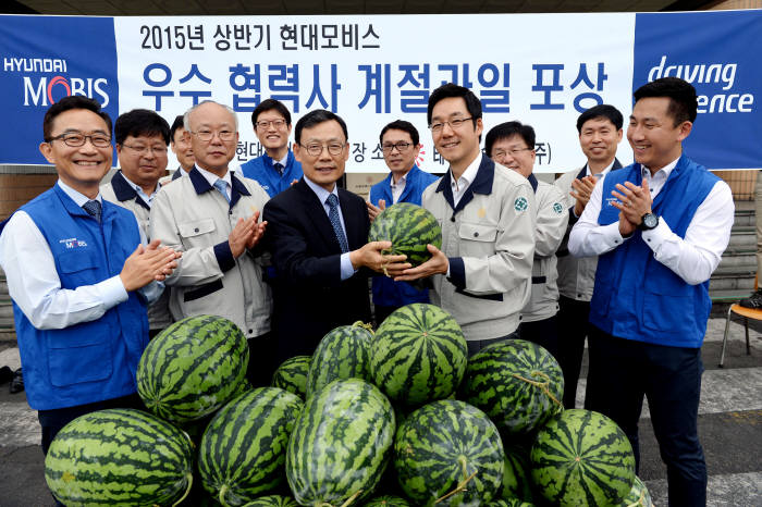 노태호 현대모비스 통합구매담당 상무(앞줄 왼쪽 세 번째)가 우수 협력사를 방문해 수박을 전달하고 있다.