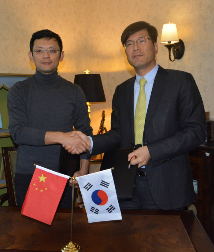 루카스 지 시스트란인터내셔널 회장(오른쪽)과 거 커 킹소프트 CEO가 18일 중국 베이징에서 라이선스 계약 체결 후 악수했다.
