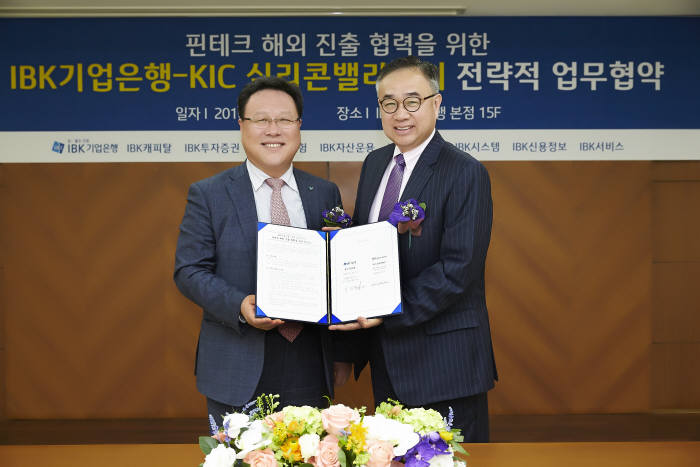 시석중 기업은행 마케팅그룹 부행장(왼쪽)과 이헌수 KIC 실리콘밸리 센터장이 협약식을 마치고 기념촬영을 하고 있는 모습.