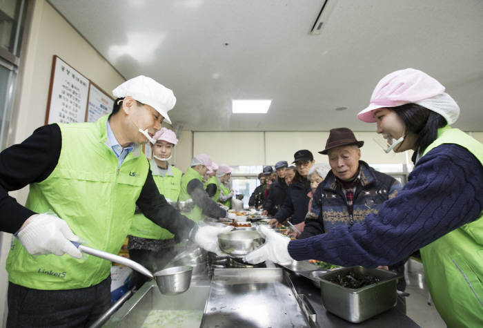 LS산전이 31일 안양시노인종합복지관에서 지역 홀몸어르신 400여명을초청해 사랑의떡국 나눔봉사를 벌였다. 박용상 LS산전 경영관리본부장(부사장·맨왼쪽)이 떡국 나눔봉사를 하고 있다.