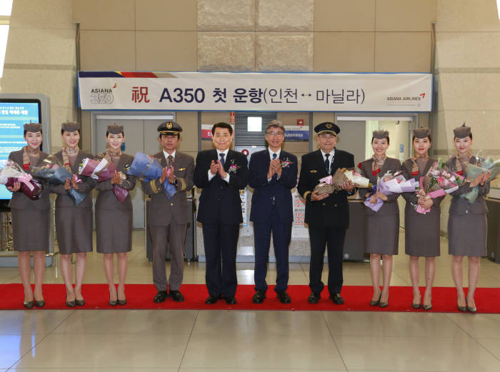 5월 15일 인천국제공항 여객터미널 출국장에서 열린 아시아나항공 A350 첫 운항 기념식에서 야마무라 아키요시 안전보안실장(왼쪽에서 6번째), 김승영 운항본부장(왼쪽에서 5번째)이 운항승무원 및 캐빈승무원들과 함께 기념촬영을 하고 있다. (제공=아시아나항공)