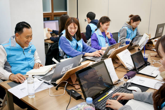 이해선 코웨이 대표이사와 신입사원은 지난 16일 서울 관악구 실로암시각장애인복지관을 찾아 봉사활동을 펼쳤다. 이해선 코웨이 대표(왼쪽 끝)와 신입사원이 시각장애인용 전자도서를 검수하고 있다.