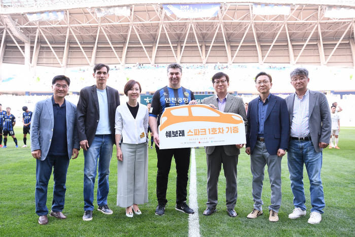 한국지엠이 한국 축구 유망주 육성을 위해 지역 유소년 축구팀 인차일드에 스파크 차량을 지원했다. 가운데 한국지엠 카허 카젬 사장과 인천아동복지협회 우치호 회장 및 행사에 참석한 한국지엠 임원 (제공=한국지엠)