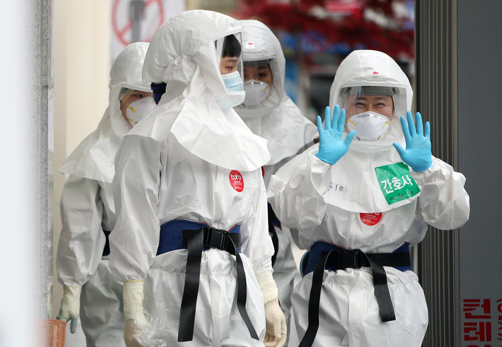 19일 대구시 계명대학교 대구동산병원 의료진들이 밝은 모습으로 코로나19 환자들이 입원한 병동으로 교대 근무를 위해 들어가고 있다. 연합뉴스