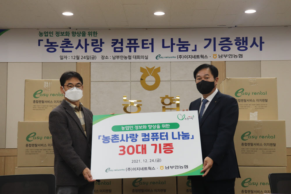 박무병 이지네트웍스 회장(왼쪽)과 최우식 남부안농협 조합장이 남부안농협 대회의실에서 농촌사람 컴퓨터 나눔 기증식을 갖고 기념촬영했다.