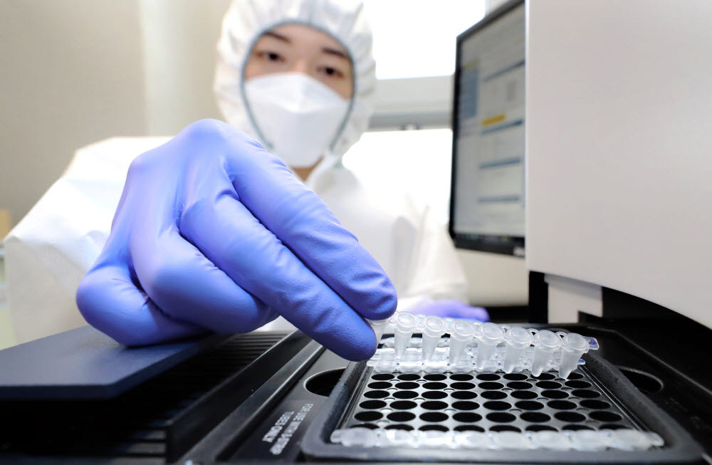 세종보건환경연구원 보건연구사가 30일 세종시 조치원읍 세종보건환경연구원에서 신종 코로나바이러스 감염증(코로나19) 오미크론 변이 신속 분석을 위해 검체를 실시간 PCR증폭 장비에 넣고 있다.