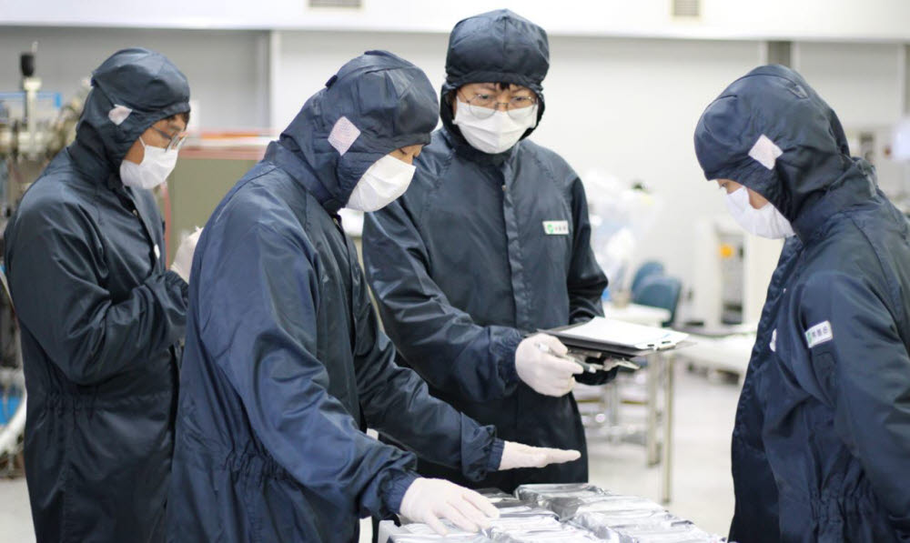 아이브이웍스 직원들이 대전 공장에서 반도체 제품 살펴보고 있다