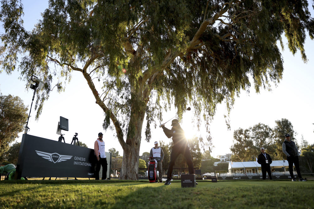 Dustin Johnson tees off on the 15th hole during the Genesis Invitational pro-am golf event at Riviera Country Club, Wednesday, Feb. 16, 2022, in the Pacific Palisades area of Los Angeles. (AP Photo/Ryan Kang)