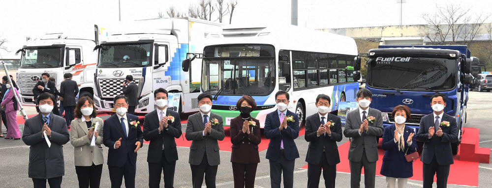 한정애 환경부 장관(왼쪽 여섯 번째)과 정원대 현대차 국내지원사업부장(오른쪽 세 번째) 등 관계자들이 24일 경기 평택시 시립운동장에서 열린 평택시 수소 모빌리티 특구 조성 업무 협약식을 마치고 수소 상용차를 배경으로 기념 촬영을 하고 있다.