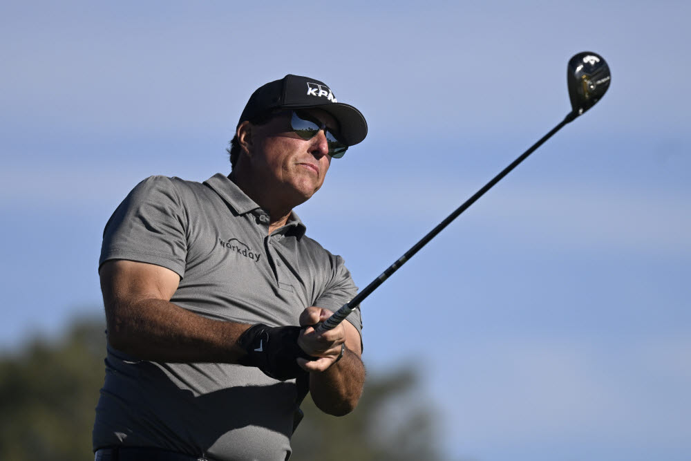 FILE - Phil Mickelson hits his tee shot on the fifth hole of the South Course at Torrey Pines during the first round of the Farmers Insurance Open golf tournament Jan. 26, 2022, in San Diego. Mickelson has said he has asked for a release from the PGA Tour for the option to play in the Saudi-funded LIV Golf Invitational in England. (AP Photo/Denis Poroy, File) FILE PHOTO