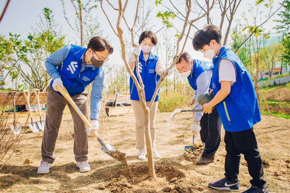 장호준 SC제일은행 소매금융그룹장 부행장(사진 왼쪽 첫번째)과 임직원, 가족들이 지난 27일 서울 양천구 안양천 둔치에서 열린 SC제일은행 착한 숲 조성 행사에서 나무를 심고 있다.