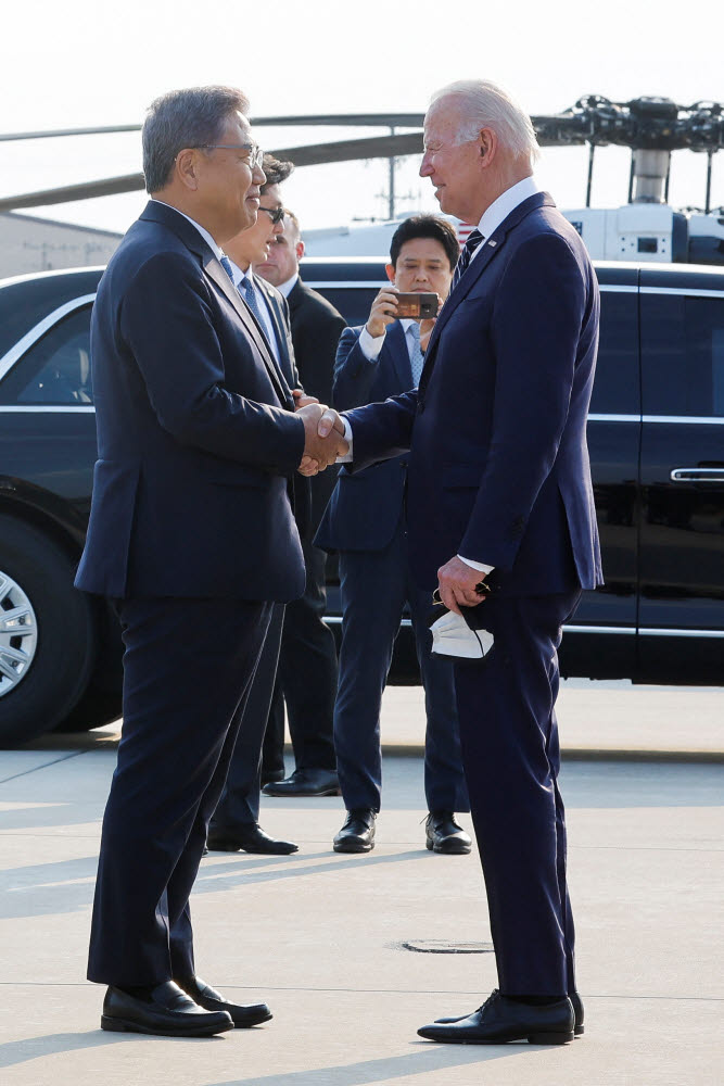 조 바이든 미국 대통령이 20일 한국 오산 공군기지에 도착해 박진 외교부 장관과 악수를 나누고 있다.<연합뉴스>