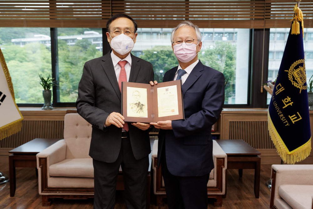 감사패 전달 후 오세정 서울대 총장(사진 왼쪽)과 박광범 메가젠임플란트 대표가 기념촬영을 하고 있다.