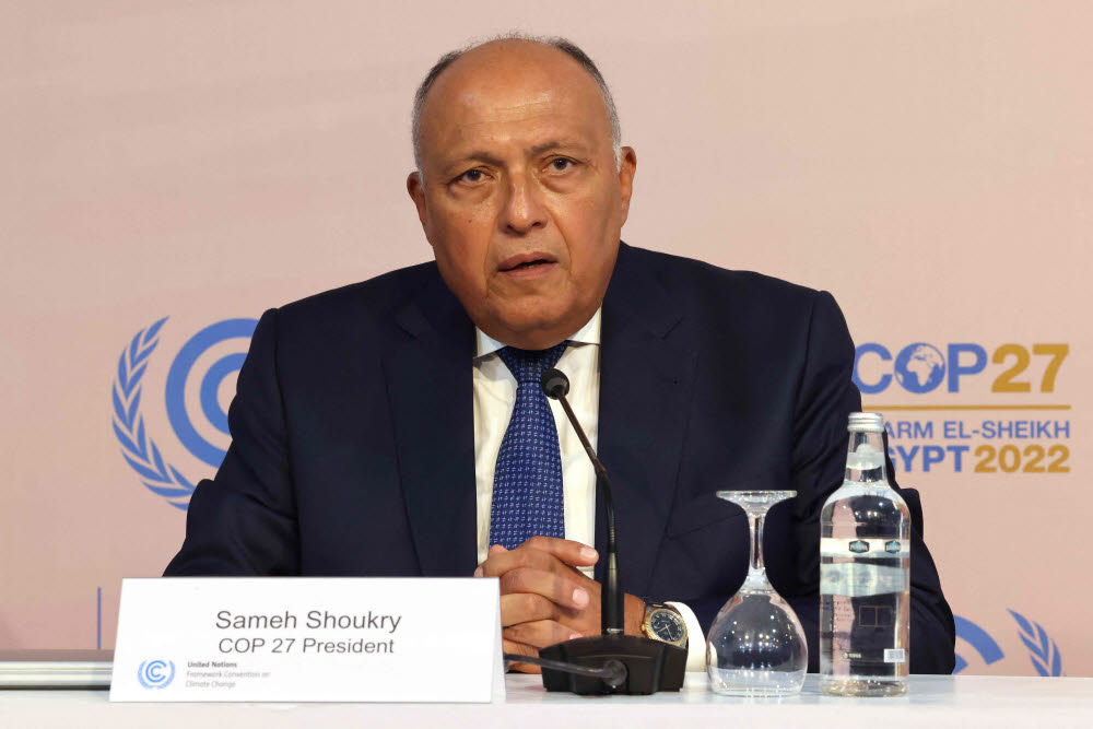 COP27 President Sameh Shoukry speaks during a press conference following the opening ceremony of the 2022 United Nations Climate Change Conference, more commonly known as COP27, at the Sharm El Sheikh International Convention Centre, in Egypts Red Sea resort of the same name. - The UNs COP27 climate summit kicked off in Egypt with warnings against backsliding on efforts to cut emissions and calls for rich nations to compensate poor countries after a year of extreme weather disasters. (Photo by JOSEPH EID / AFP)