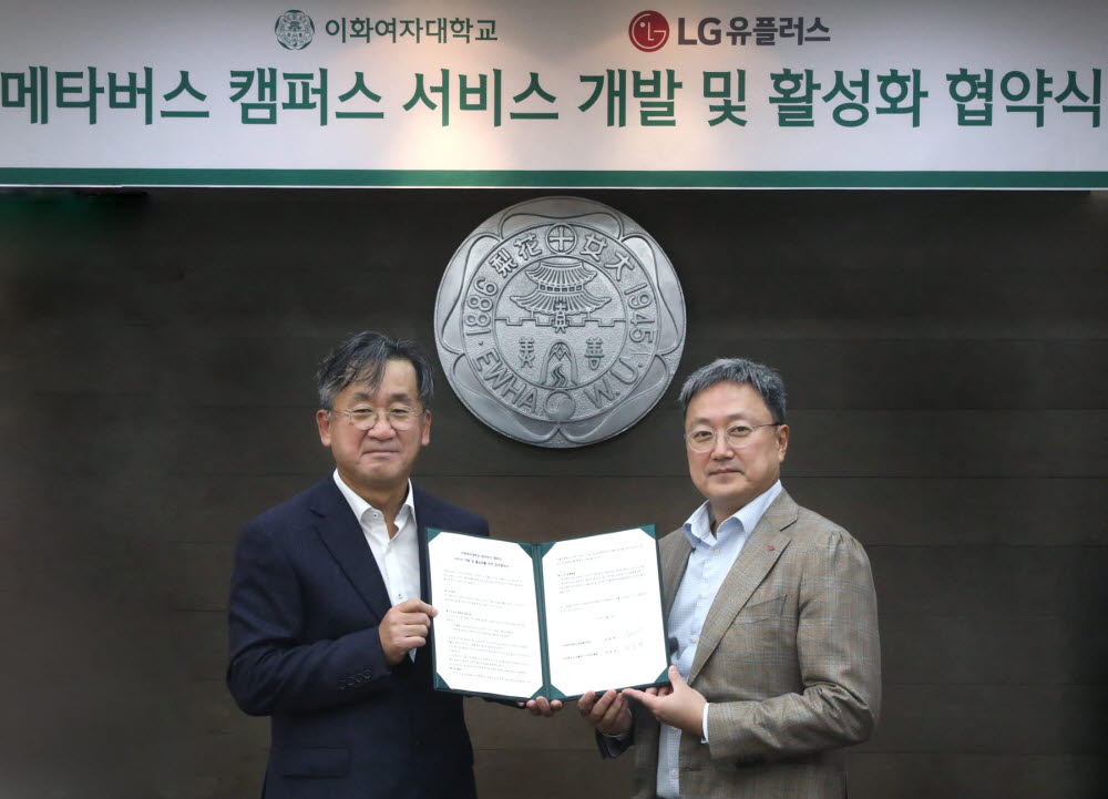 업무협약식에서 임장혁 LG유플러스 기업신사업그룹장(오른쪽)과 김정태 이화여대 정보통신처장이 기념촬영을 하고 있다.